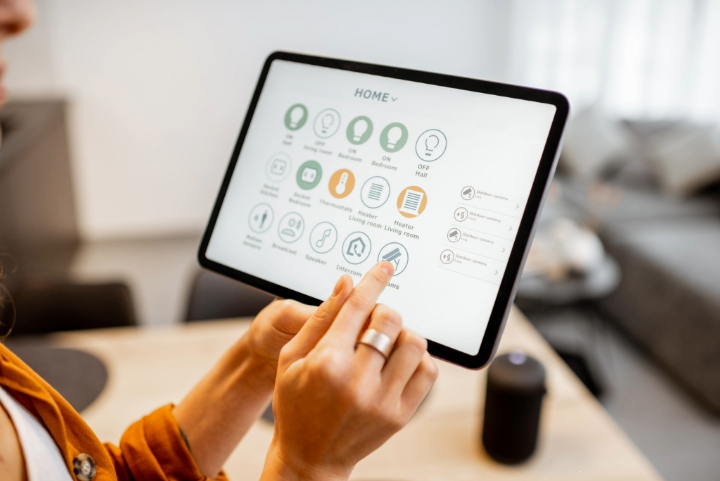 Business owner using tablet to control devices and automation systems