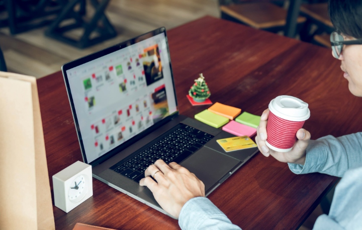 Man holding laptop and typing keyboard looking product for shopping online.